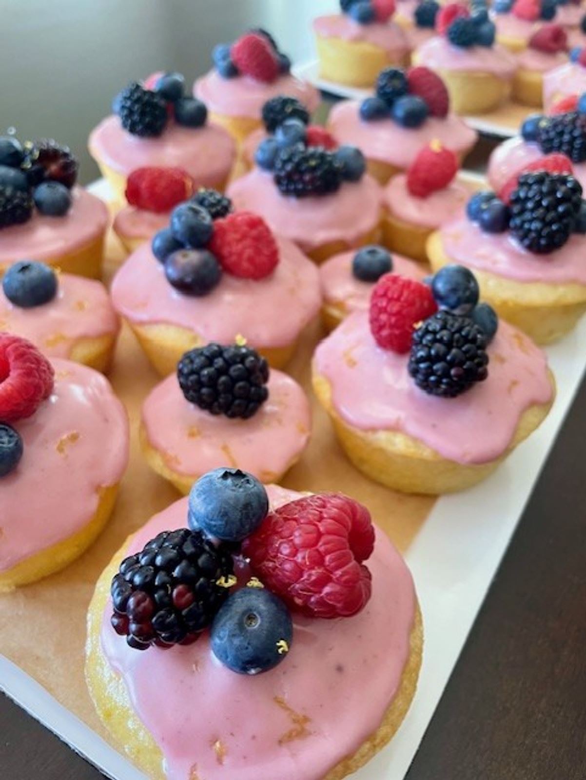 Lemon berry cupcakes with blackberry glaze and fresh berries