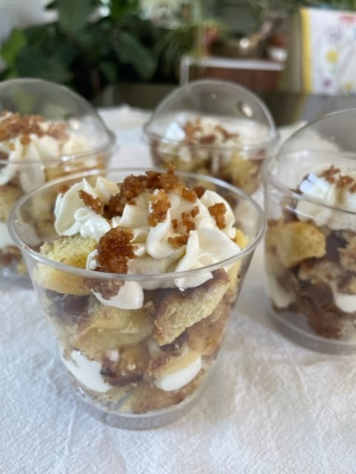 Dessert cups layered with cake, cream and brown sugar crumble