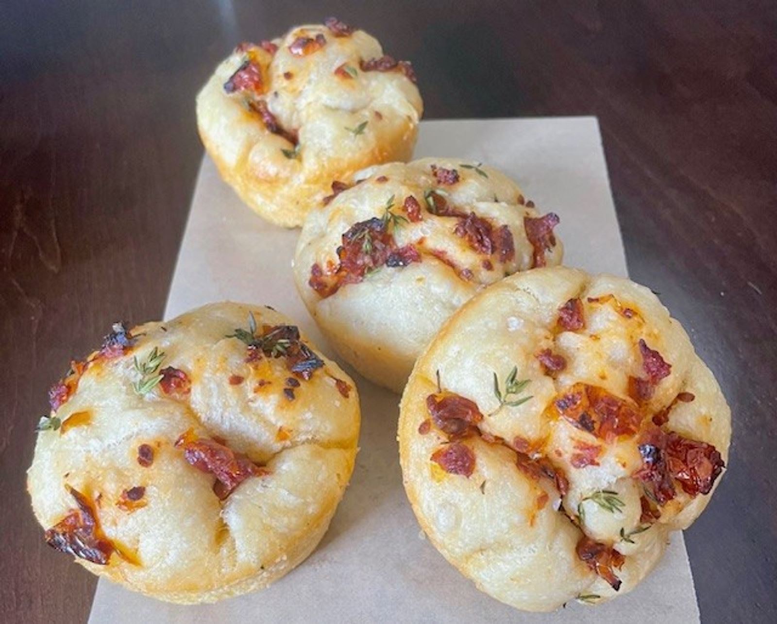 Sourdough focaccia rolls topped with sundried tomato and thyme