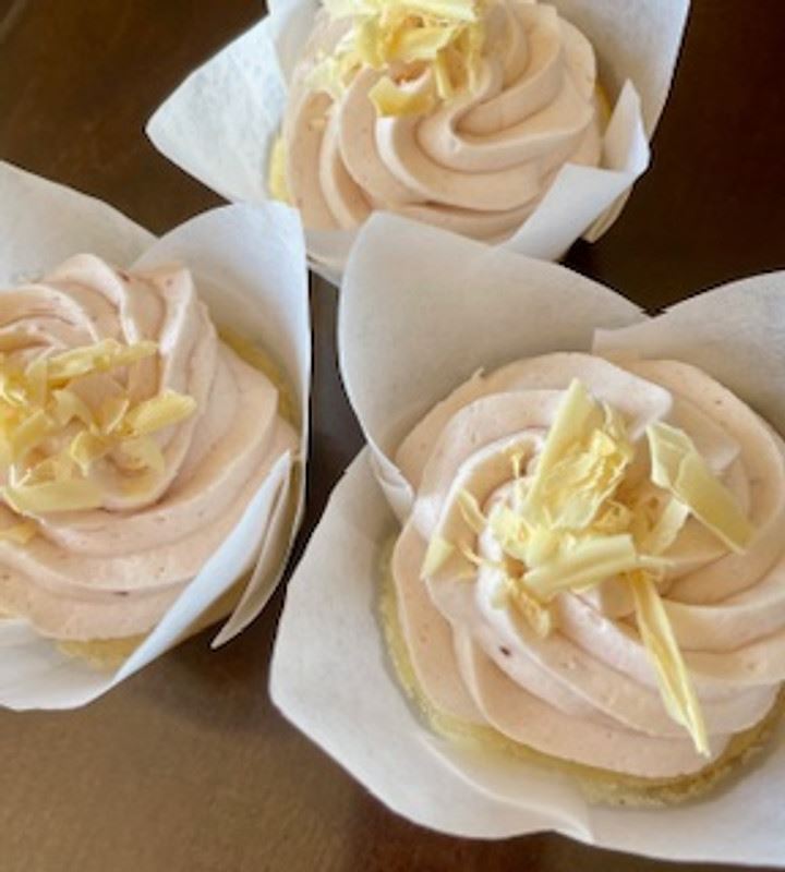 Strawberries and cream cupcakes with white chocolate shavings