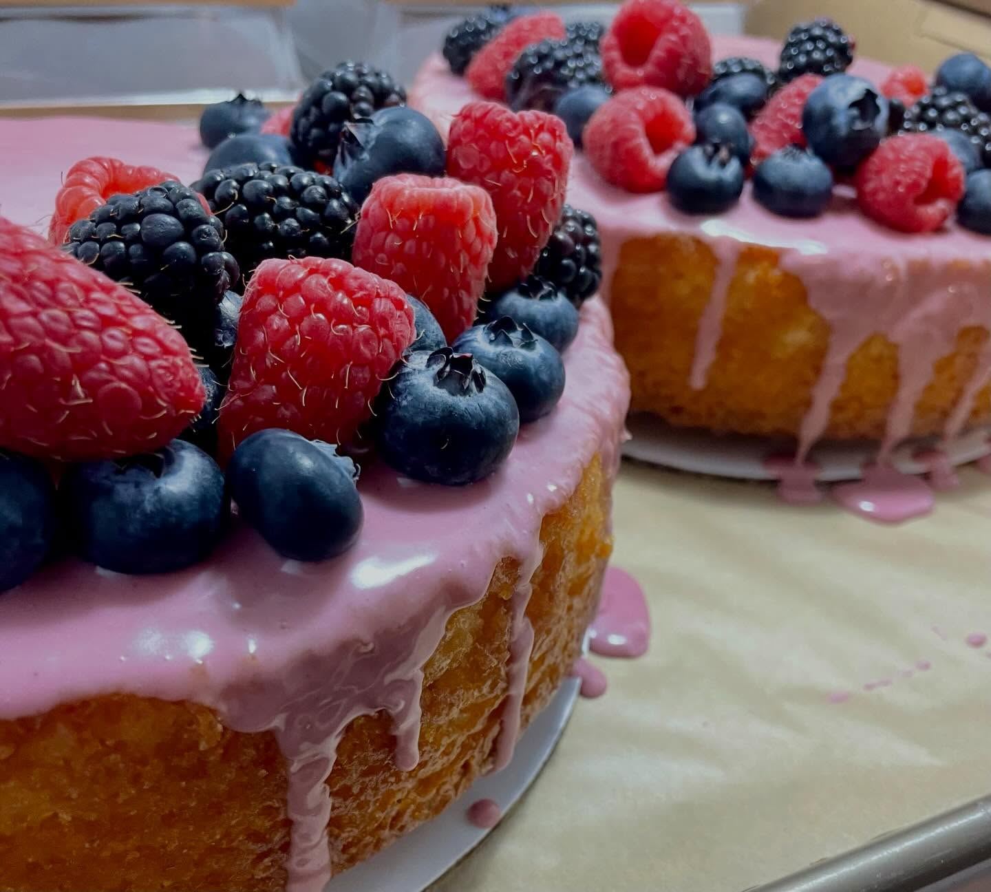 Lemon pound cakes with blackberry glaze topped with fresh raspberries, blueberries and blackberries